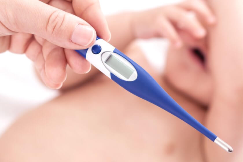 Digitales Fieberthermometer Mutter misst mit digitalem Kinder-Fieberthermometer die Temperatur bei ihrem Baby